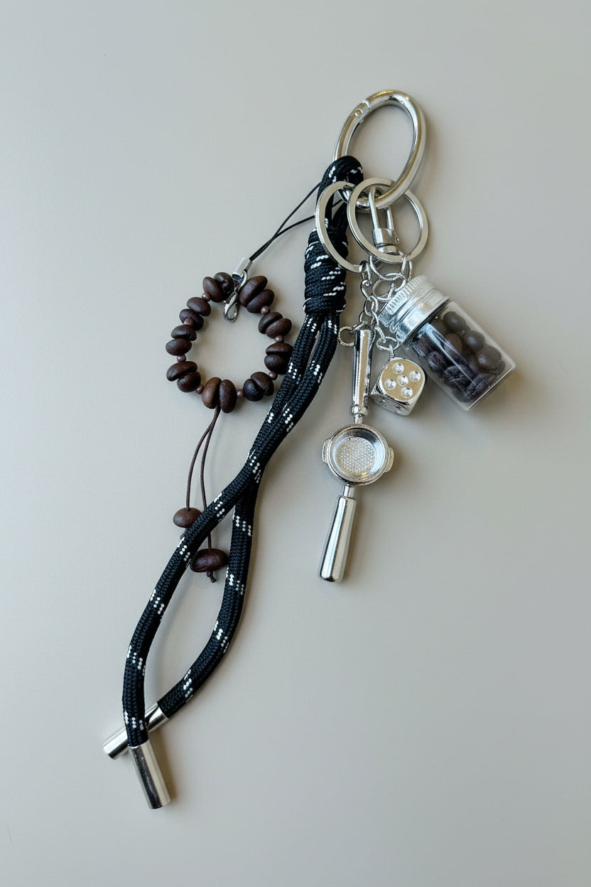 coffee bean Keychain with various charms on a brown surface