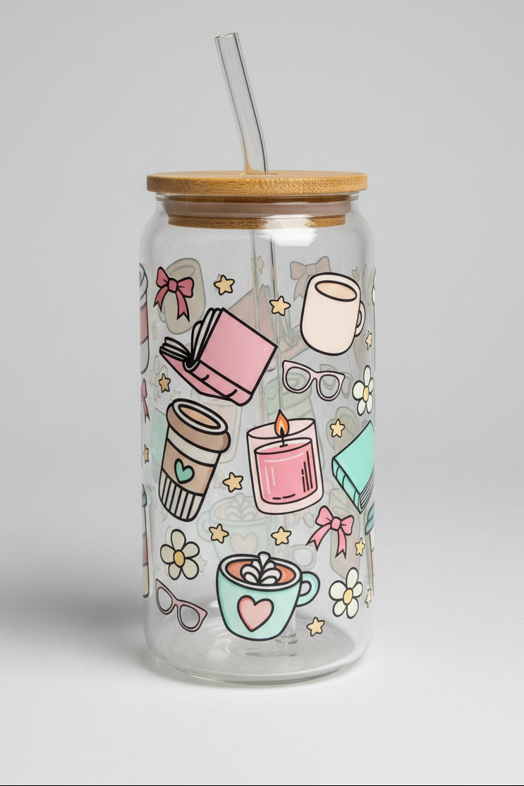 Clear glass jar with colorful illustrations and a wooden lid on a wooden surface outdoors.
