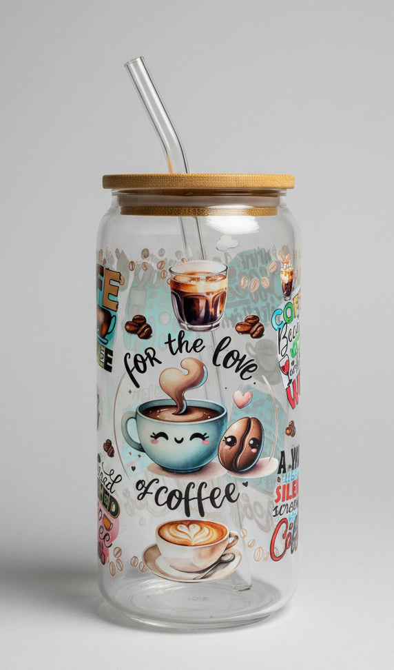 Glass tumbler with coffee-themed illustrations and text on a wooden surface outdoors.