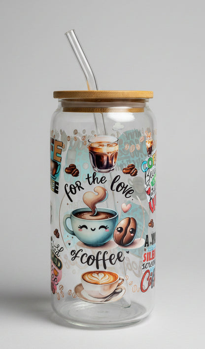 Glass tumbler with coffee-themed illustrations and text on a wooden surface outdoors.