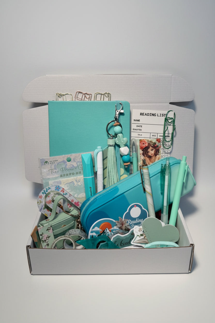 A collection of teal green stationary with notebook, pencil pouch and accessories
